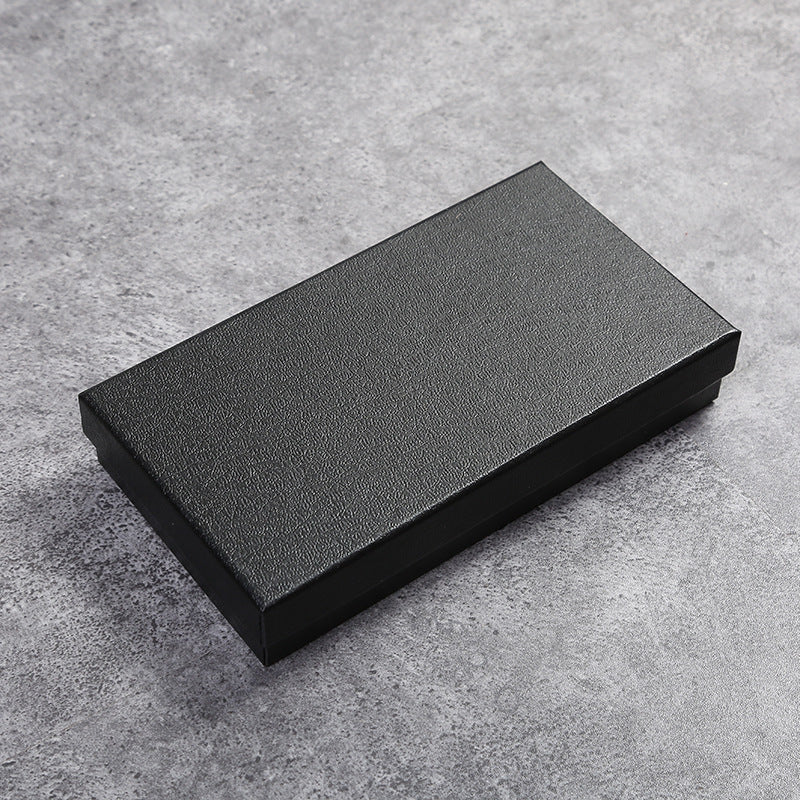 Black rectangular box on a gray concrete surface