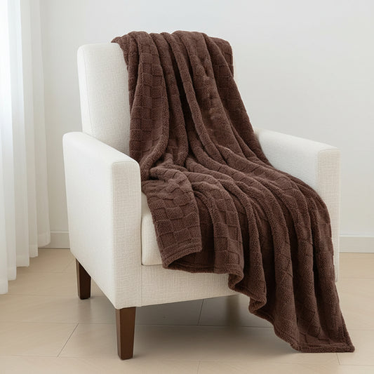 Mocha Brown textured blanket on a bed in a bright bedroom with white furniture and decor.