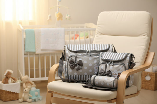 Gray and white striped diaper bag set with polka dots and bows on a white background
