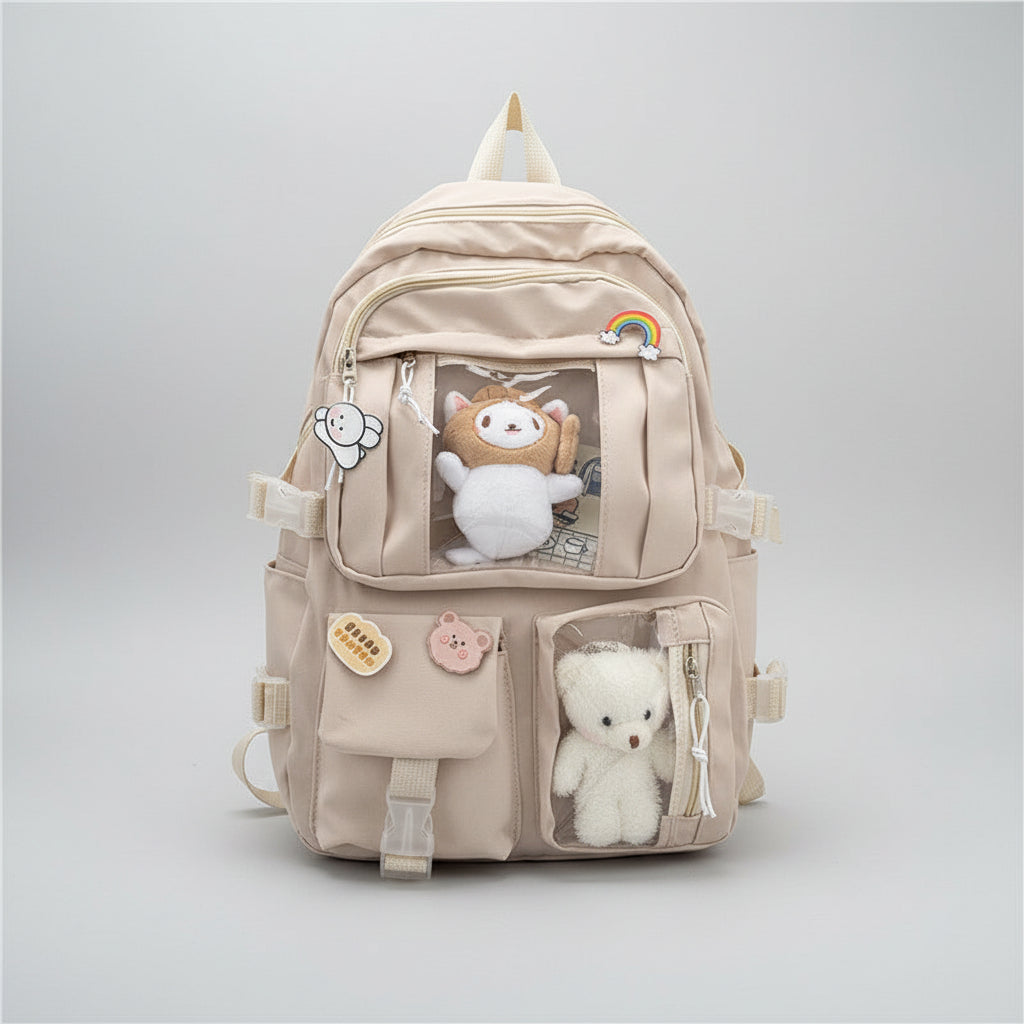 A beige canvas backpack with multiple front pockets, decorative patches, and plush toy windows, hanging on a wall hook in a styled room setting with headphones and stationery visible.