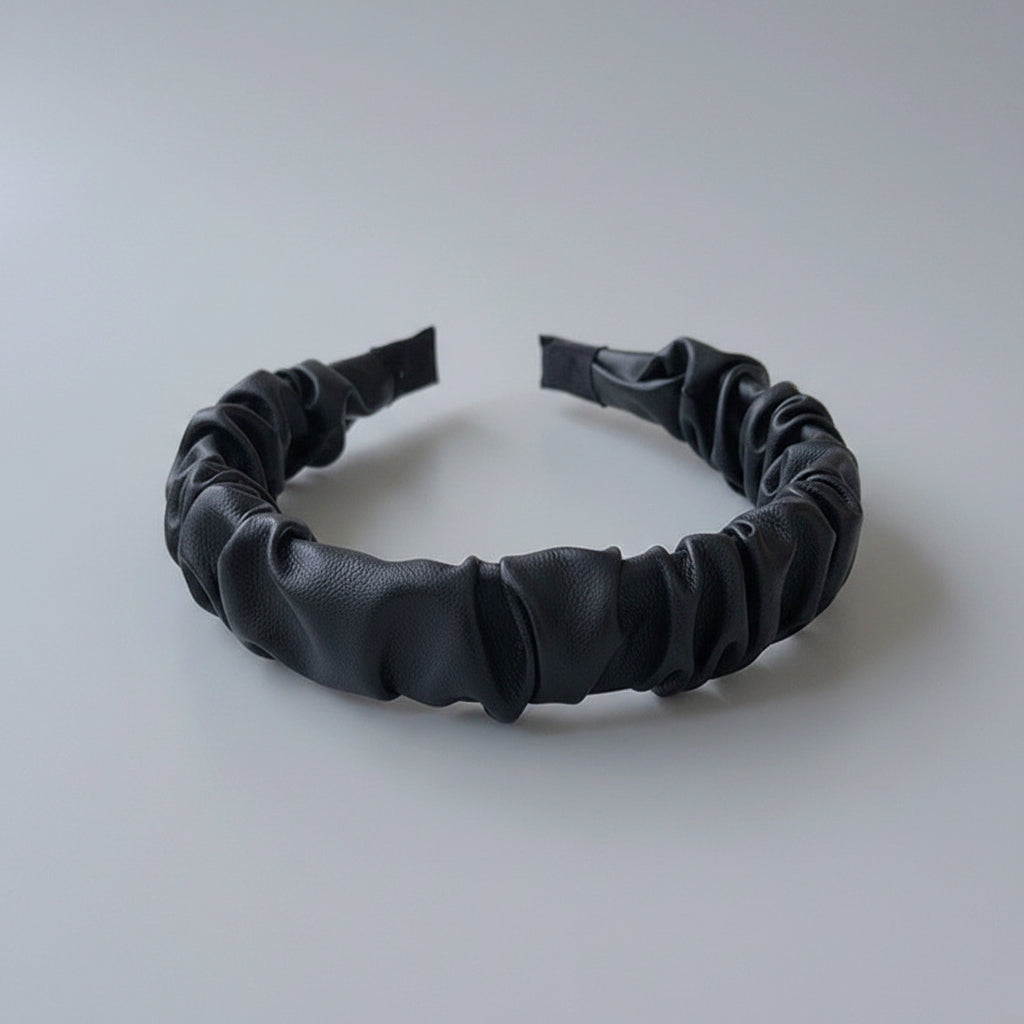 Black headband on a white surface
