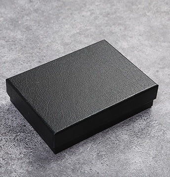 Black rectangular box on a gray concrete surface