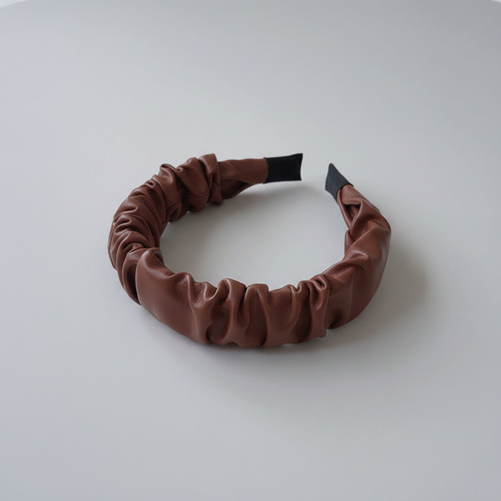 Brown headband on a white surface