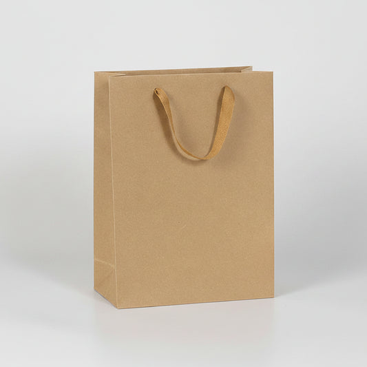 Brown paper bag with dimensions labeled next to a bottle on a white background
