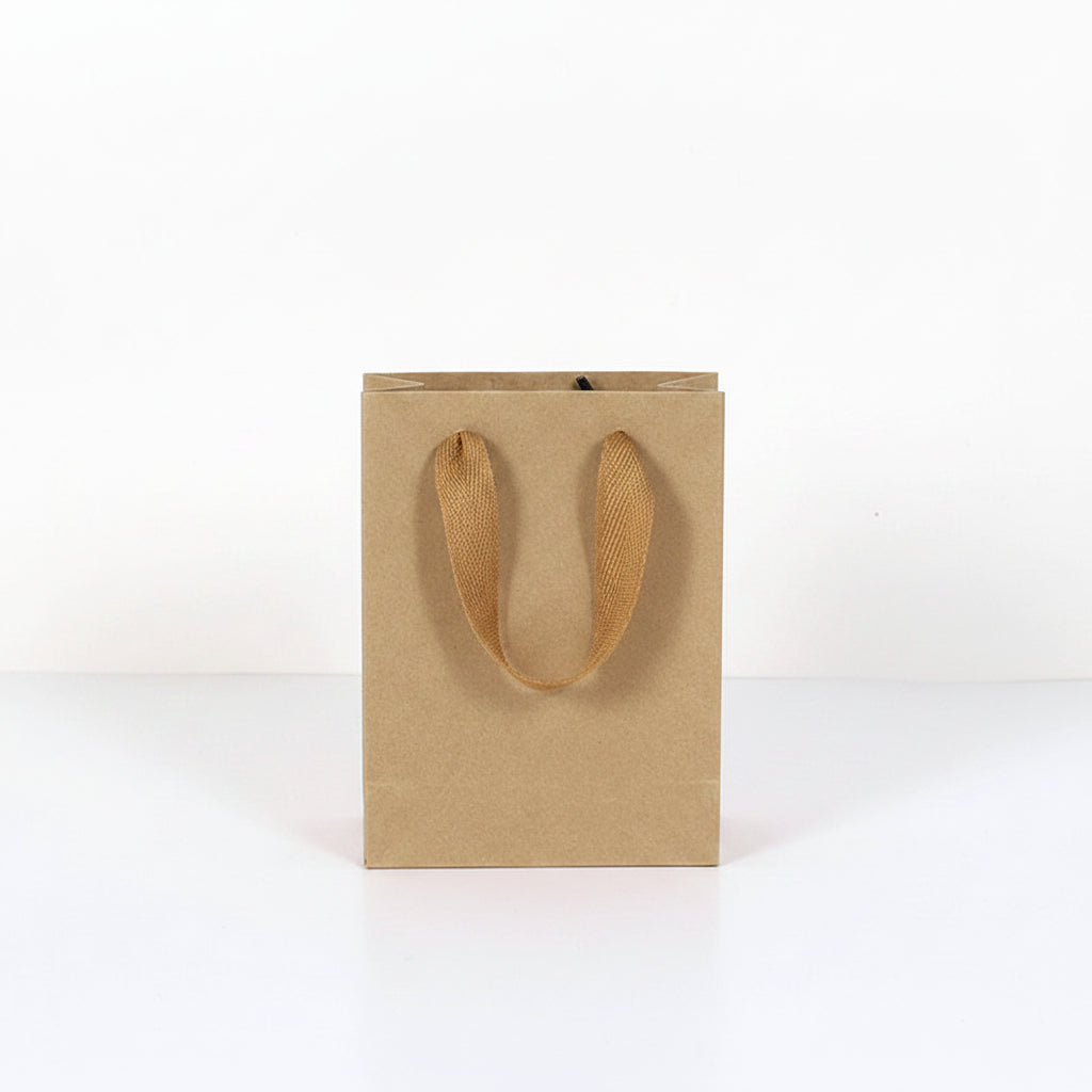 Kraft paper bag with handles next to a water bottle, showing dimensions.