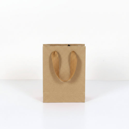 Kraft paper bag with handles next to a water bottle, showing dimensions.
