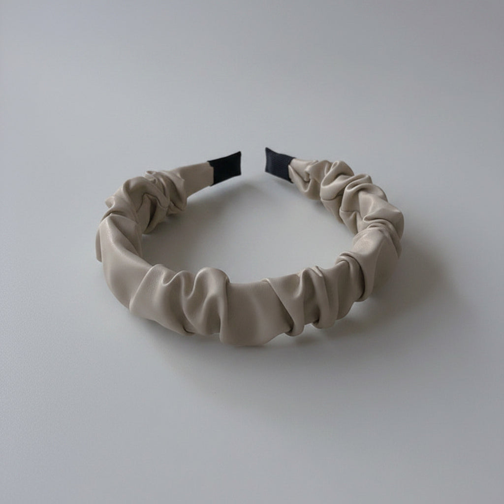 Beige headband on a white surface