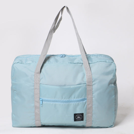 Light blue foldable bag with gray straps on a white background