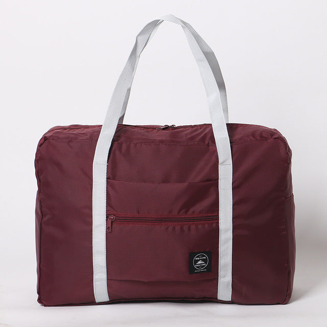 Maroon duffel bag with white straps on a light gray background