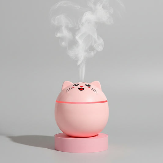 Cat-shaped humidifier emitting mist on a pink background