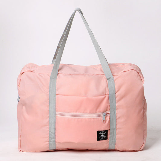 Pink duffel bag with gray straps on a white background