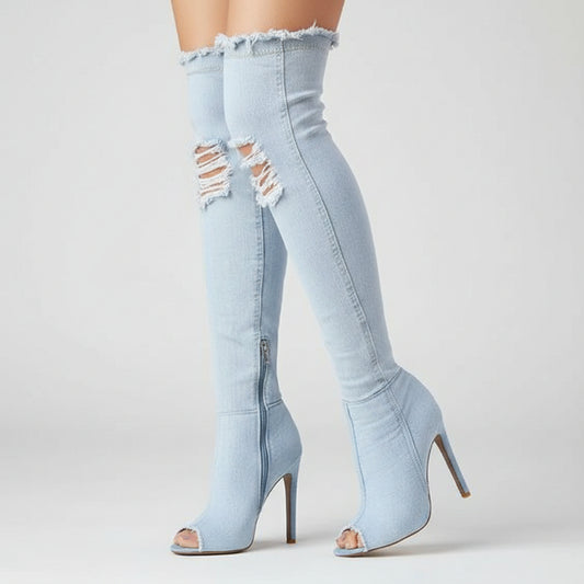 Sky Blue ripped jeans and high-heeled shoes worn by a person on a sidewalk.