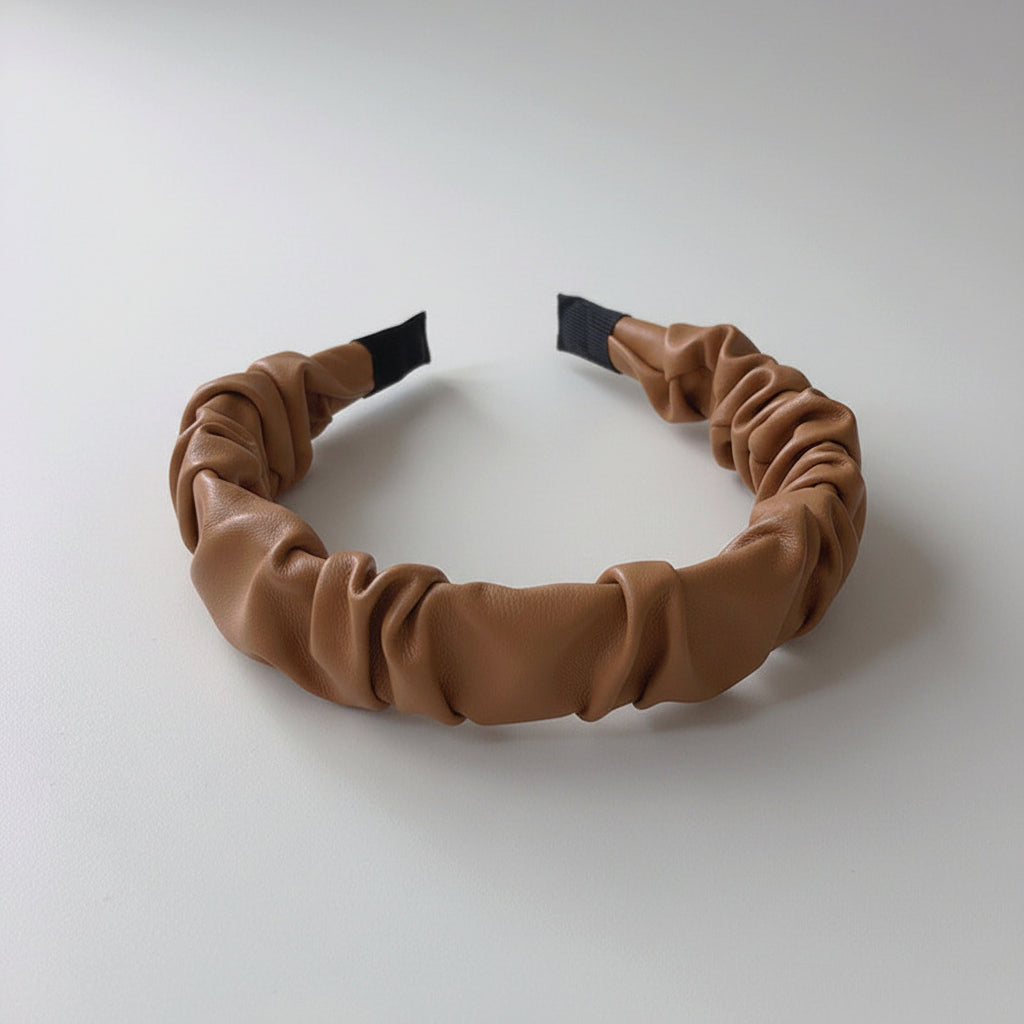 Brown headband on a white surface