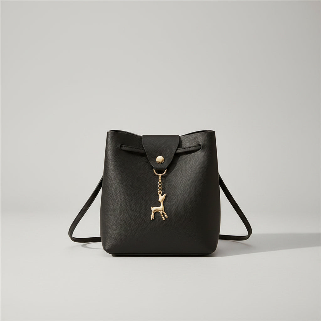 Black handbag with a gold deer charm on a white background